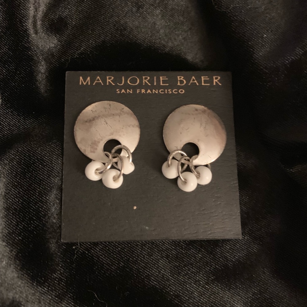 Silver colored earrings with white beads